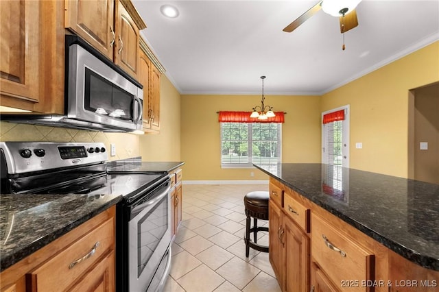 22 Hand Ln, Eldon, MO 65026 - kitchen with stainless steel appliances, tasteful backsplash, ornamental molding, light tile patterned floors, and pendant lighting