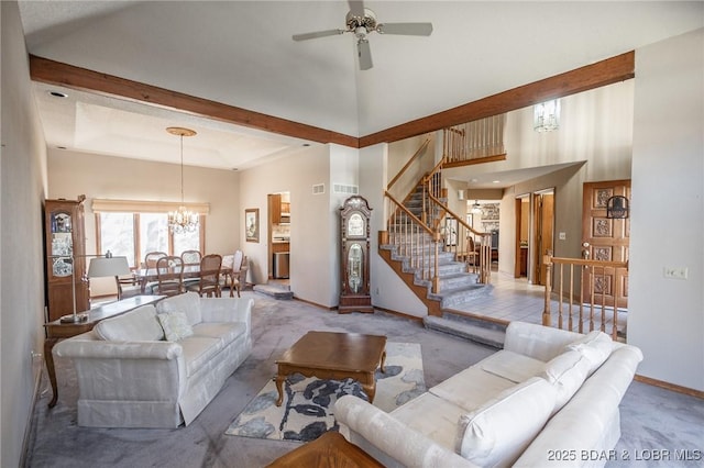 170 Twin Oaks Dr, Lake Ozark, MO 65049 - carpeted living room with a chandelier, a ceiling fan, stairs, and a towering ceiling