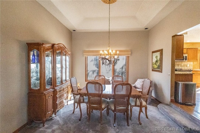 170 Twin Oaks Dr, Lake Ozark, MO 65049 - dining room with a chandelier, dark colored carpet, and a tray ceiling