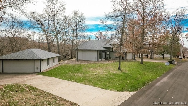 170 Twin Oaks Dr, Lake Ozark, MO 65049 - view of front of house with a front yard, an outdoor structure, and driveway