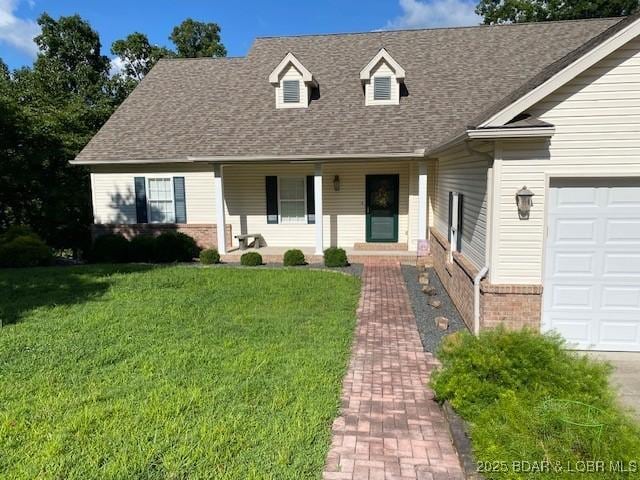130 Guinevere Ct, Camdenton, MO 65020 - view of front of home featuring covered porch, a front lawn, a shingled roof, brick siding, and an attached garage