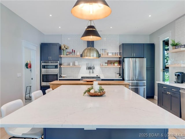 92 Arrowhead Beach Rd, Lake Ozark, MO 65049 - kitchen featuring open shelves, stainless steel appliances, tasteful backsplash, light stone counters, and pendant lighting