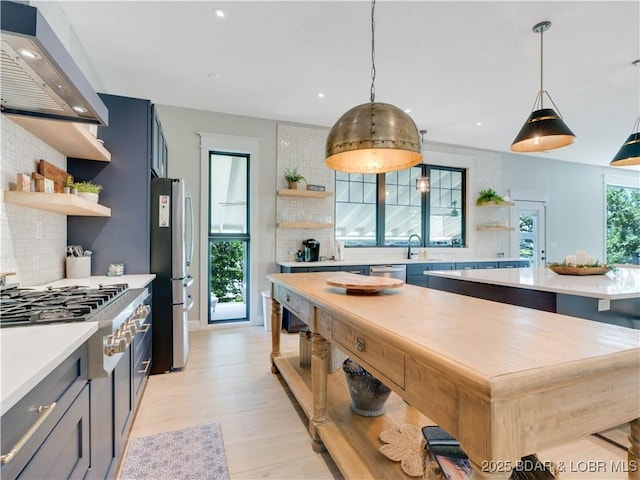 92 Arrowhead Beach Rd, Lake Ozark, MO 65049 - kitchen with open shelves, stainless steel appliances, ventilation hood, tasteful backsplash, and recessed lighting