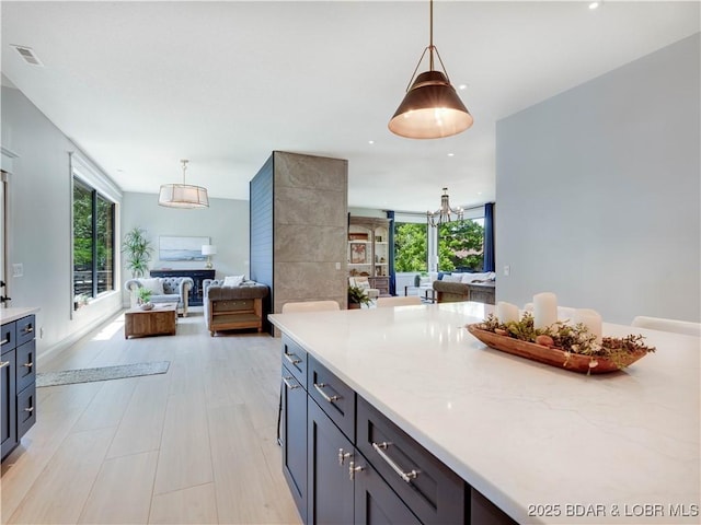 92 Arrowhead Beach Rd, Lake Ozark, MO 65049 - kitchen featuring open floor plan, hanging light fixtures, light stone counters, and recessed lighting
