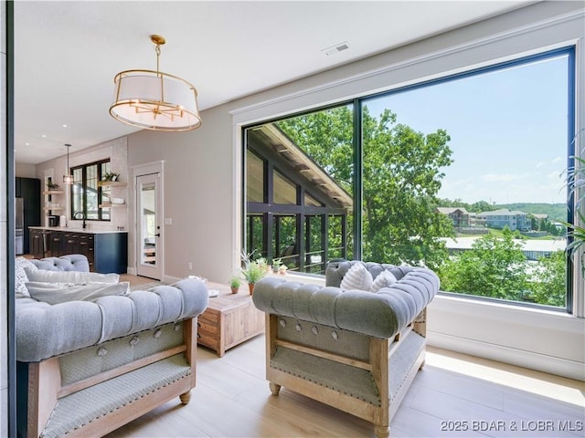92 Arrowhead Beach Rd, Lake Ozark, MO 65049 - living room featuring plenty of natural light and a chandelier