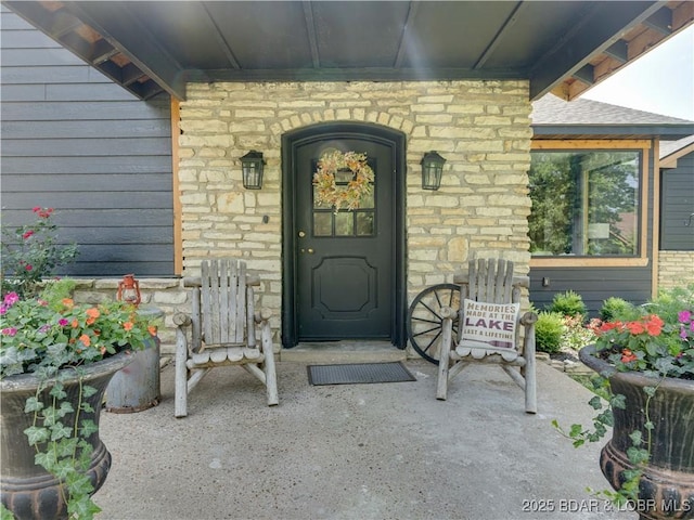 92 Arrowhead Beach Rd, Lake Ozark, MO 65049 - doorway to property featuring stone siding and a porch