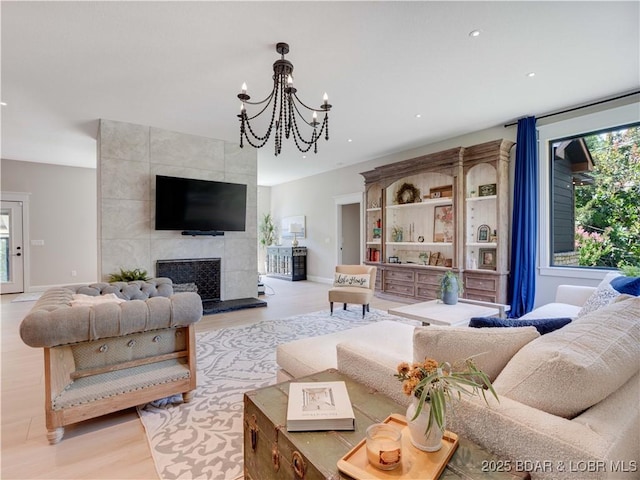 92 Arrowhead Beach Rd, Lake Ozark, MO 65049 - living area featuring light wood-type flooring, recessed lighting, a chandelier, and a tiled fireplace