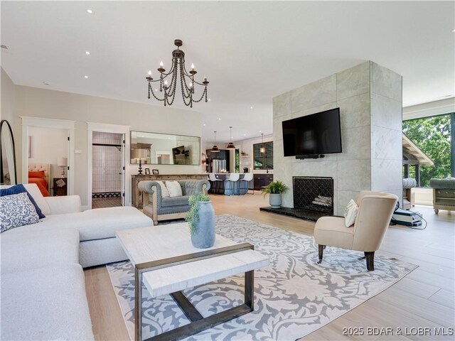 92 Arrowhead Beach Rd, Lake Ozark, MO 65049 - living area featuring a chandelier, light wood-style floors, recessed lighting, and a tile fireplace