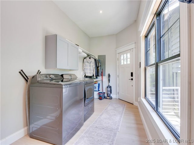 92 Arrowhead Beach Rd, Lake Ozark, MO 65049 - washroom with separate washer and dryer, cabinet space, and light wood-type flooring