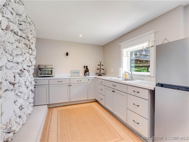 92 Arrowhead Beach Rd, Lake Ozark, MO 65049 - kitchen with freestanding refrigerator and light countertops