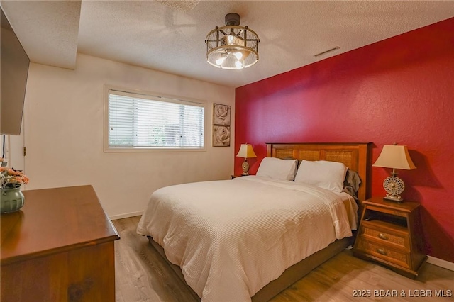 35 Port Bagnell W, Eldon, MO 65026 - bedroom with wood finished floors and a textured ceiling