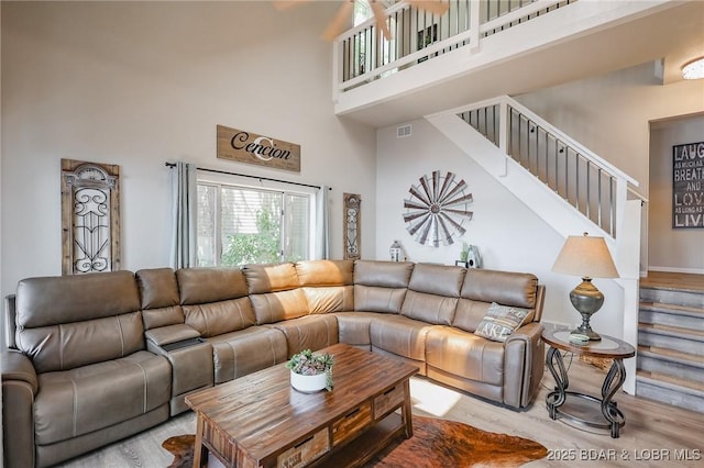35 Port Bagnell W, Eldon, MO 65026 - living area with a high ceiling, stairs, and wood finished floors
