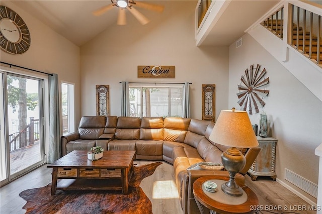 35 Port Bagnell W, Eldon, MO 65026 - living area with wood finished floors, a ceiling fan, high vaulted ceiling, and stairway
