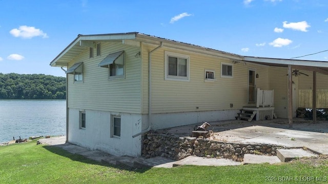 27527 Clyne Dr, Barnett, MO 65011 - rear view of property featuring a water view, a fire pit, and a ceiling fan