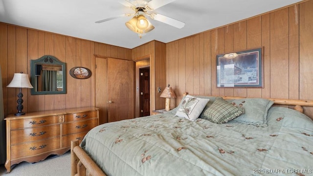 27527 Clyne Dr, Barnett, MO 65011 - bedroom with wooden walls, light colored carpet, and a ceiling fan