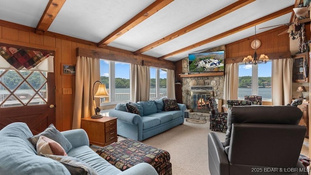27527 Clyne Dr, Barnett, MO 65011 - carpeted living area featuring a chandelier, wood walls, and a fireplace