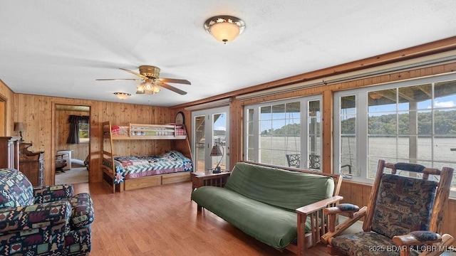 27527 Clyne Dr, Barnett, MO 65011 - bedroom with wooden walls, access to outside, wood finished floors, and a water view