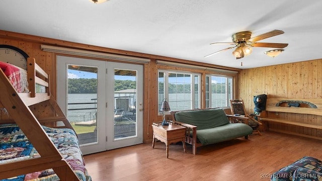 27527 Clyne Dr, Barnett, MO 65011 - bedroom with access to exterior, multiple windows, wooden walls, wood finished floors, and a water view