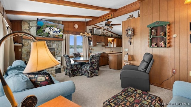 27527 Clyne Dr, Barnett, MO 65011 - living area featuring light colored carpet, wooden walls, a ceiling fan, and a fireplace