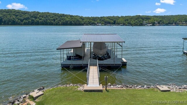 27527 Clyne Dr, Barnett, MO 65011 - dock area featuring a water view, boat lift, and a view of trees