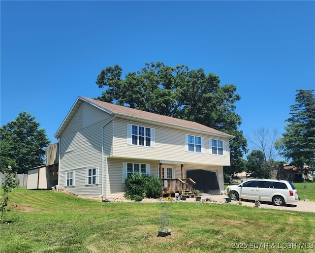 133 Ha Ha Tonka Rd, Camdenton, MO 65020 - colonial house featuring an attached garage, a front lawn, and concrete driveway