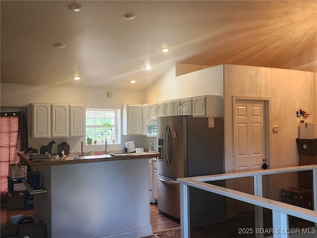 133 Ha Ha Tonka Rd, Camdenton, MO 65020 - kitchen featuring stainless steel fridge, white microwave, vaulted ceiling, recessed lighting, and dark wood-style floors