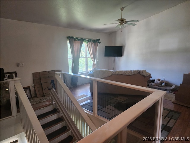 133 Ha Ha Tonka Rd, Camdenton, MO 65020 - staircase featuring ceiling fan and wood finished floors