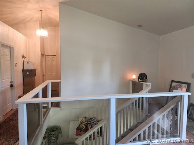 133 Ha Ha Tonka Rd, Camdenton, MO 65020 - stairway with a chandelier, vaulted ceiling, and wood finished floors