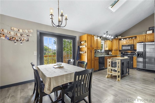 4741 Clearwood Ln, Osage Beach, MO 65065 - dining space with a chandelier, vaulted ceiling, and light wood-style floors