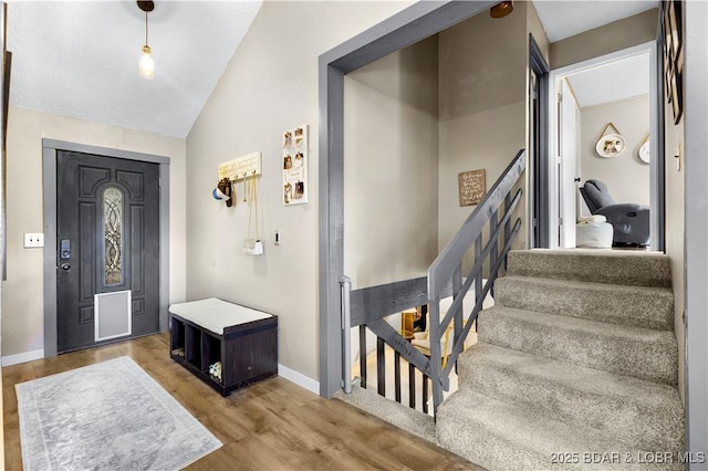 4741 Clearwood Ln, Osage Beach, MO 65065 - foyer entrance featuring vaulted ceiling, wood finished floors, and stairway