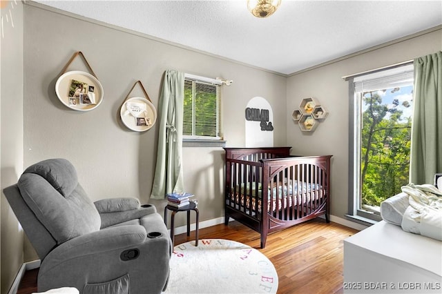 4741 Clearwood Ln, Osage Beach, MO 65065 - bedroom featuring wood finished floors and a crib