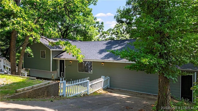 4741 Clearwood Ln, Osage Beach, MO 65065 - split level home featuring roof with shingles and driveway