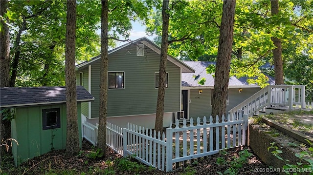 4741 Clearwood Ln, Osage Beach, MO 65065 - back of house featuring a storage shed and roof with shingles