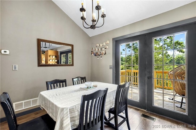 4741 Clearwood Ln, Osage Beach, MO 65065 - dining area with dark wood-style floors, a chandelier, french doors, and high vaulted ceiling