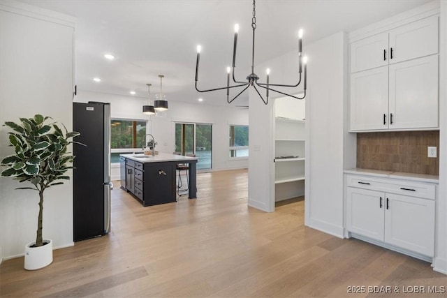 30586 Rapids Holw, Stover, MO 65037 - kitchen featuring freestanding refrigerator, light wood-type flooring, light countertops, tasteful backsplash, and recessed lighting