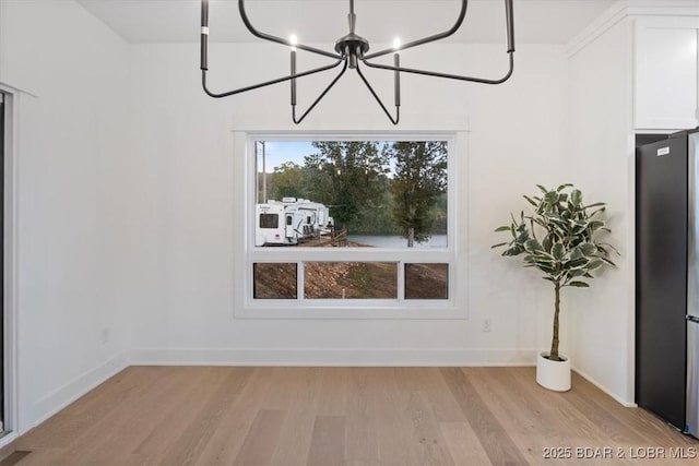 30586 Rapids Holw, Stover, MO 65037 - unfurnished dining area featuring light wood finished floors and a chandelier