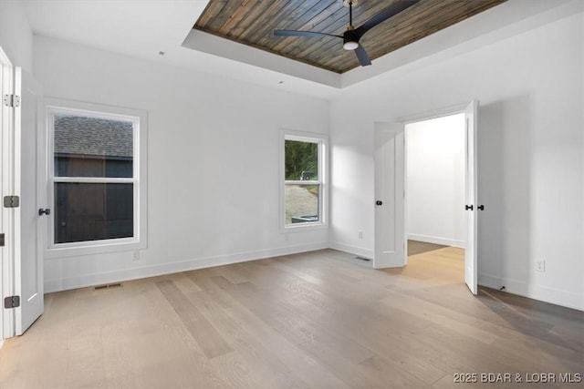 30586 Rapids Holw, Stover, MO 65037 - empty room with a ceiling fan, a raised ceiling, and light wood-type flooring