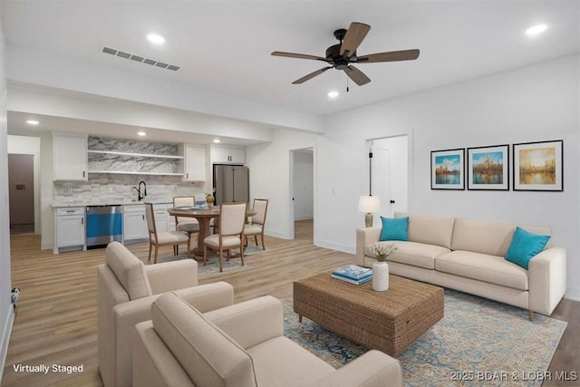 30586 Rapids Holw, Stover, MO 65037 - living room with light wood-style flooring, bar with sink, ceiling fan, and recessed lighting