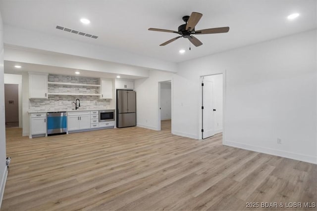 30586 Rapids Holw, Stover, MO 65037 - unfurnished living room with wet bar, light wood-style floors, recessed lighting, and a ceiling fan