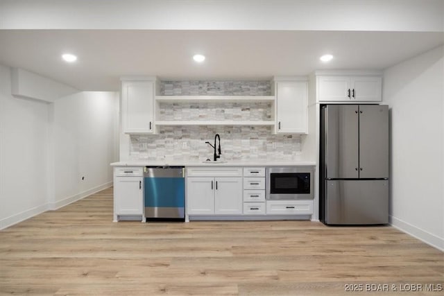 30586 Rapids Holw, Stover, MO 65037 - kitchen featuring appliances with stainless steel finishes, open shelves, white cabinets, tasteful backsplash, and recessed lighting