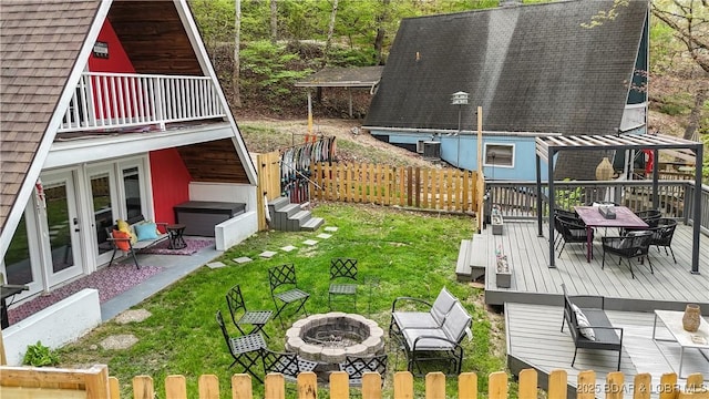 27086 Comanche Cv, Rocky Mount, MO 65072 - view of yard with an outdoor fire pit, outdoor dining space, a wooden deck, and french doors
