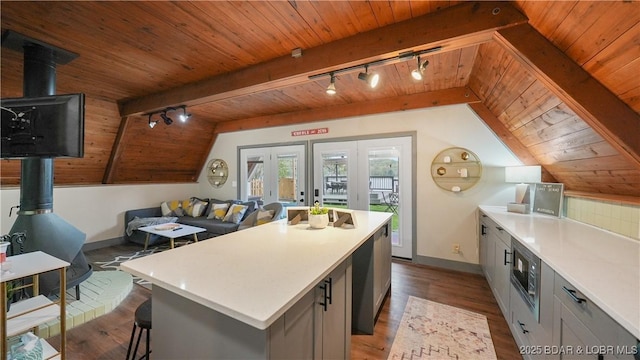 27086 Comanche Cv, Rocky Mount, MO 65072 - kitchen with a wood stove, rail lighting, wooden ceiling, wood finished floors, and a center island
