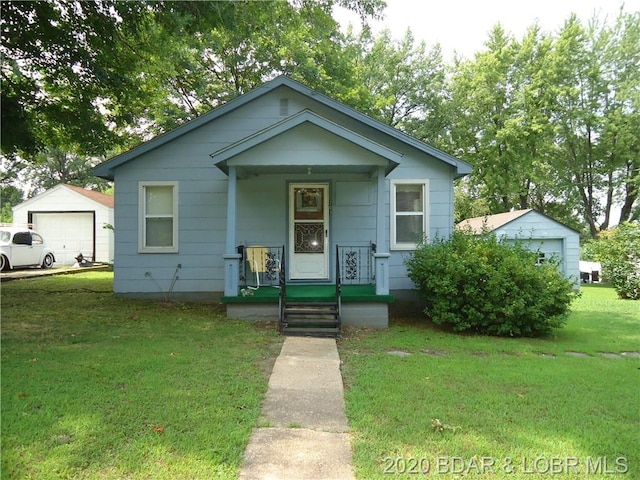 bungalow-style house with a front yard and a garage