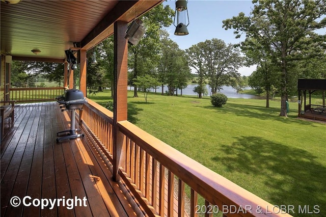 deck featuring a lawn and a water view