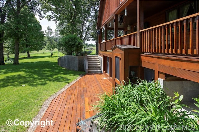 view of home's exterior featuring a wooden deck and a lawn