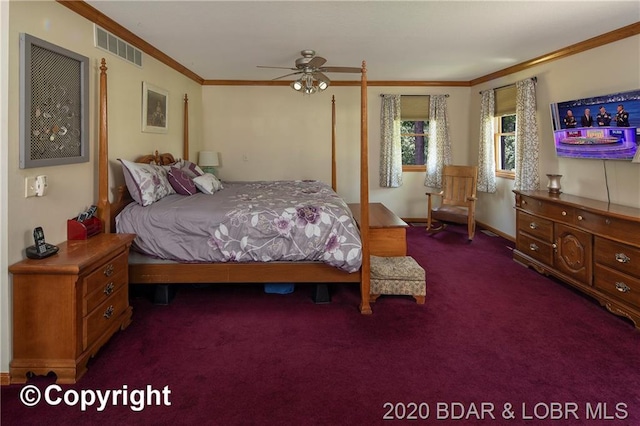 bedroom featuring dark colored carpet, crown molding, and ceiling fan