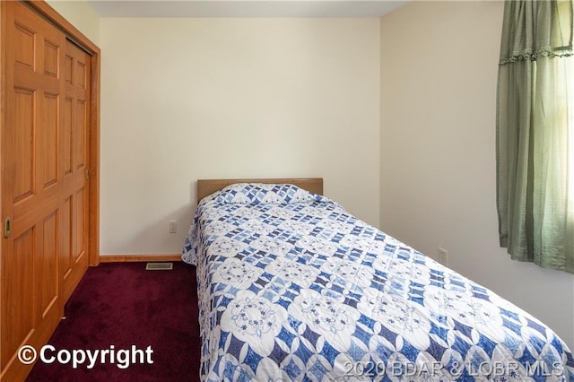 bedroom featuring dark colored carpet