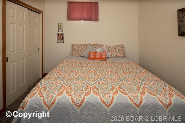 bedroom featuring a closet and carpet flooring