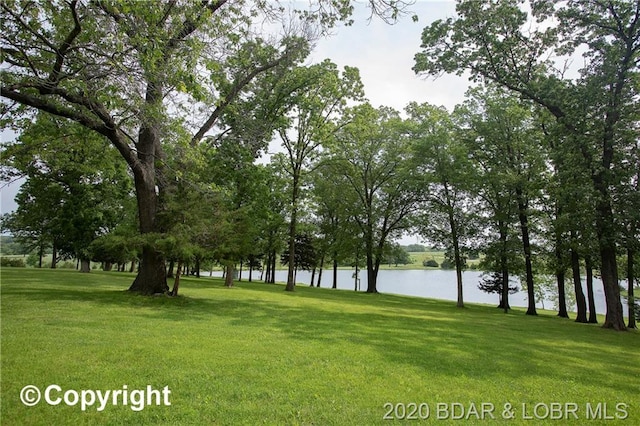 exterior space featuring a water view and a lawn