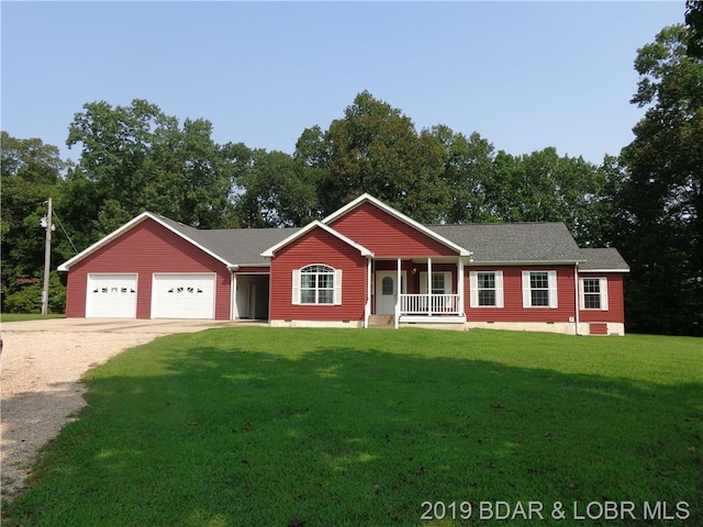 single story home with covered porch, a front yard, and a garage